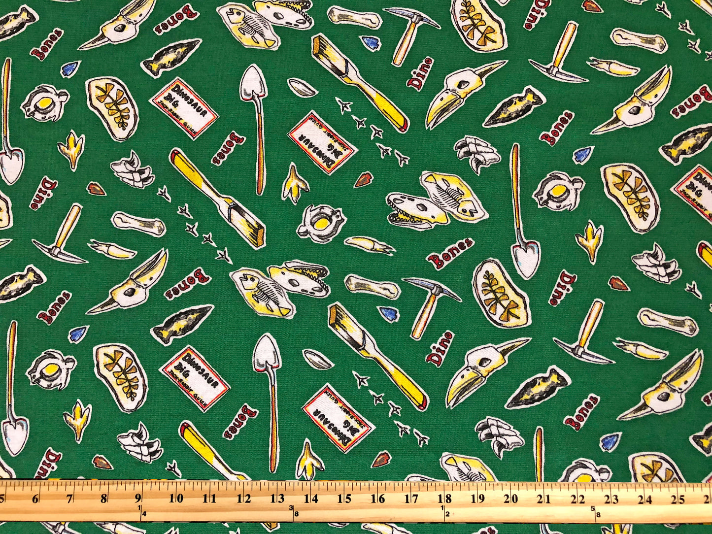 Dino Dig Cotton Print – 100% Cotton | Non-Stretch, 50″ Wide, Green Fossils & Tools – Sold by the Yard (CTJPR03)