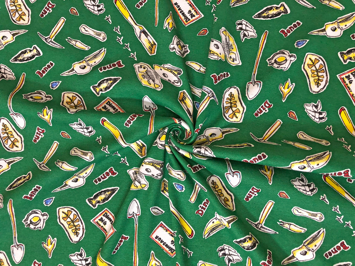 Dino Dig Cotton Print – 100% Cotton | Non-Stretch, 50″ Wide, Green Fossils & Tools – Sold by the Yard (CTJPR03)
