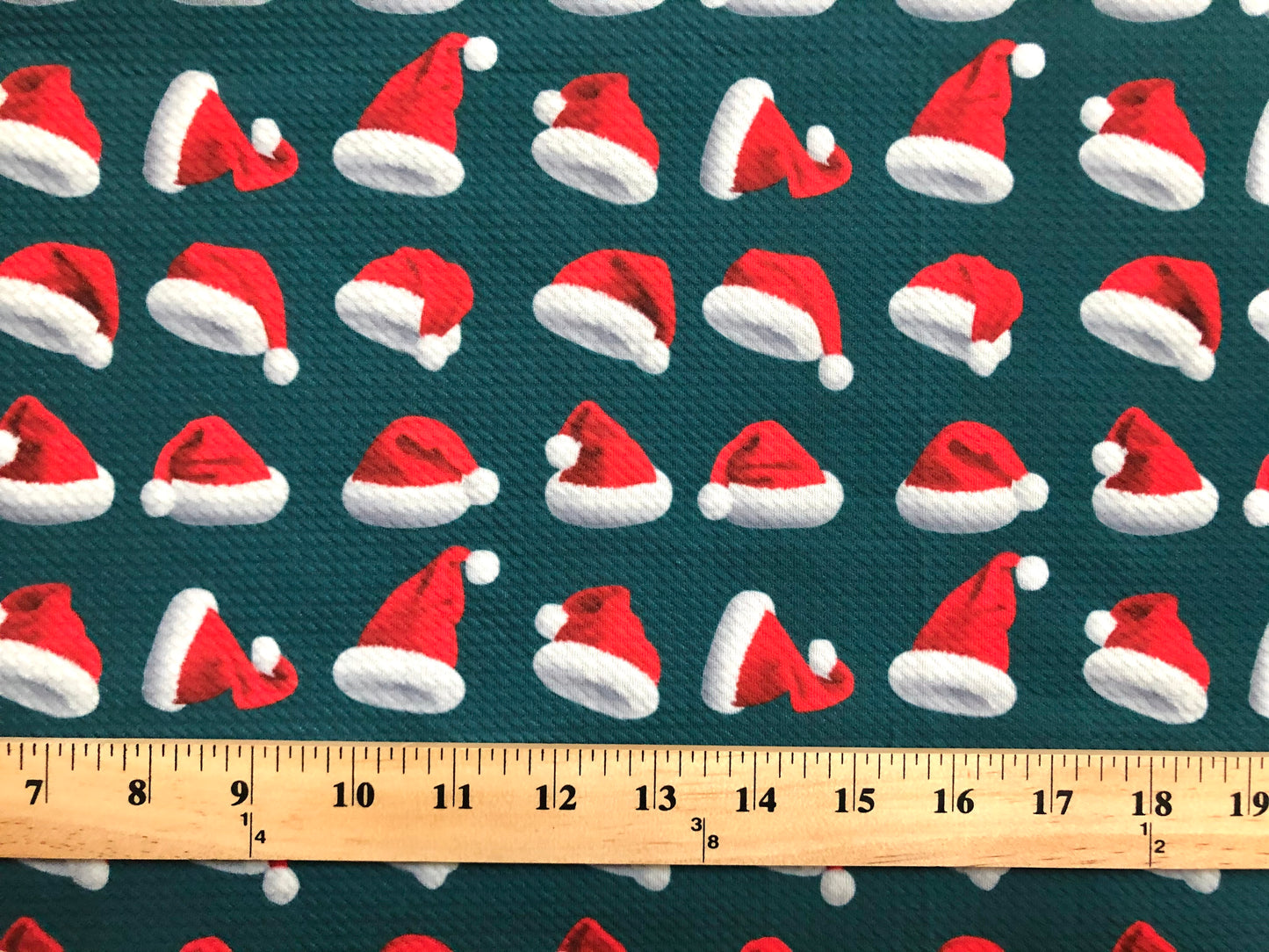Premium Bullet Knit Fabric – Red & White Santa Hat Print on Hunter Green, 56″ Wide, Sold by the Yard (BPR189)