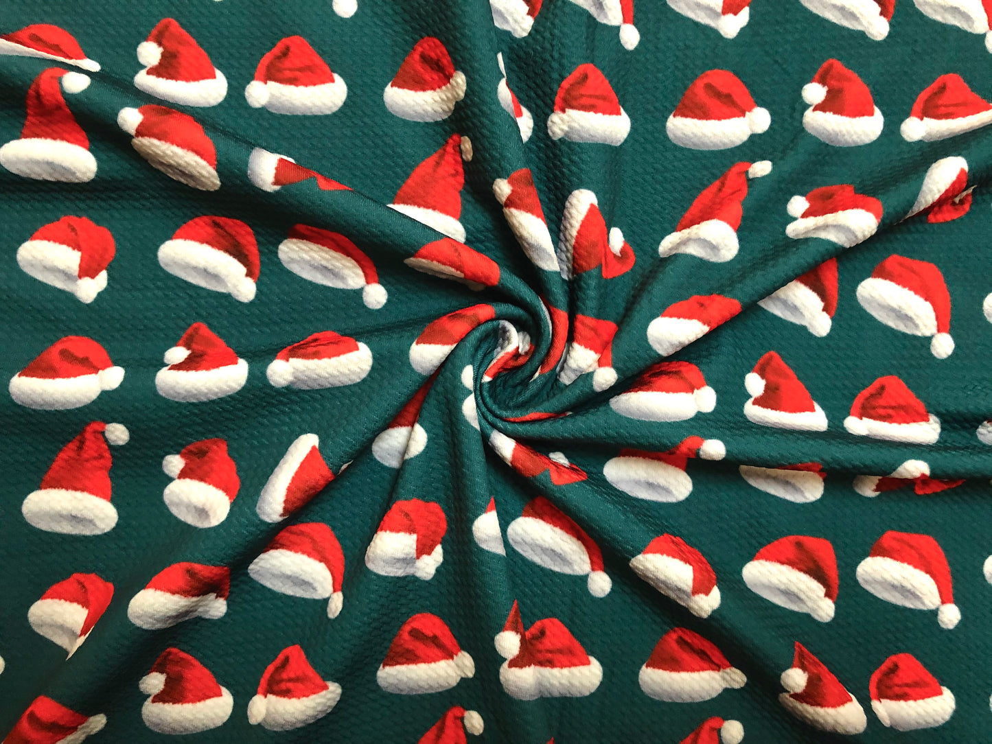 Premium Bullet Knit Fabric – Red & White Santa Hat Print on Hunter Green, 56″ Wide, Sold by the Yard (BPR189)