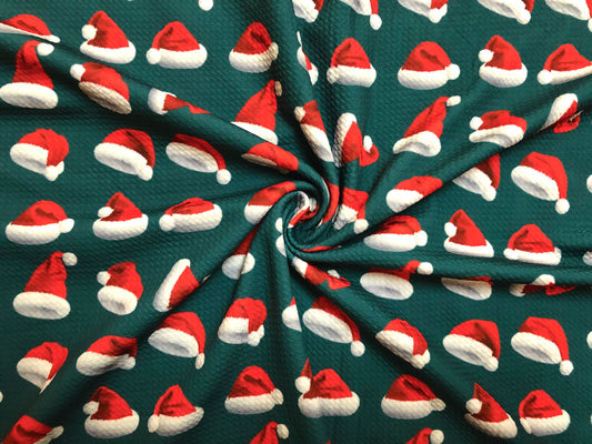 Premium Bullet Knit Fabric – Red & White Santa Hat Print on Hunter Green, 56″ Wide, Sold by the Yard (BPR189)