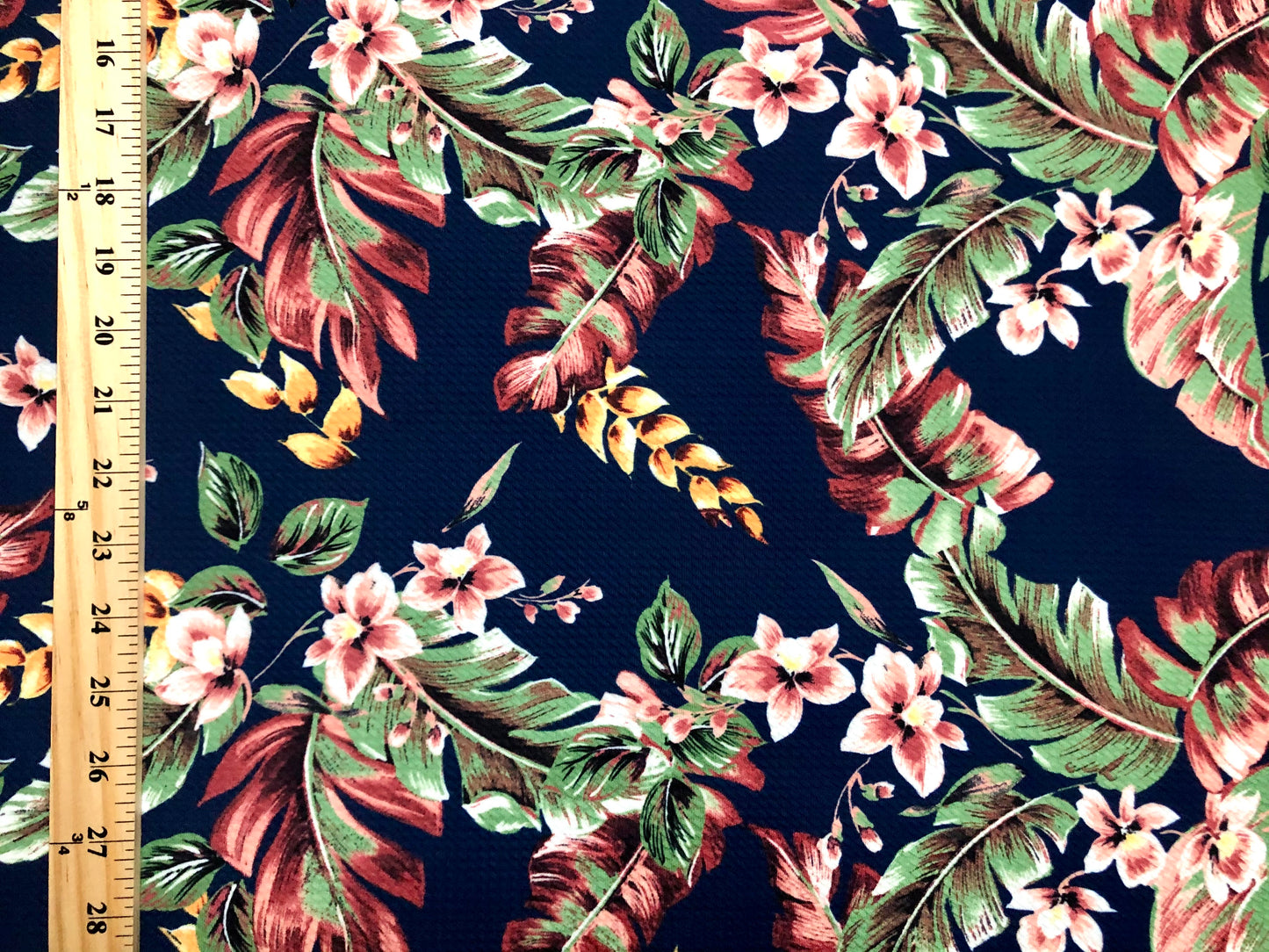 Bullet Knit Fabric – Vibrant Tropical Palm Leaf Print in Peach, Yellow & Rust on Navy Blue, 56″ Wide, Sold by the Yard (BPR233)